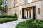 Entrance of Empire Apartments with elegant design and landscaped garden in Washington, DC.