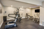 Interior view of a modern fitness center with workout machines and weights at Park Place Apartments.