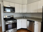 Modern kitchen with stainless steel appliances and granite countertops in 2-bedroom apartment for rent in Lynn.