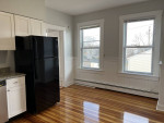 Bright kitchen in renovated 2Bed 1Bath apartment featuring modern appliances and hardwood floors