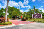 Entrance of The Park at Veneto Apartments in Fort Myers, showcasing lush landscaping and a welcoming atmosphere.