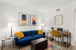 Stylish furnished apartment living room with cozy seating, desk, and modern decor in Sarasota, FL.