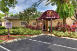 Welcome Center of Park at Murano apartments, showcasing lush landscaping and designated future resident parking.