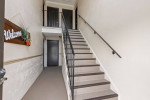 Welcoming interior entrance and staircase of The Lodge at Woodlake Apartments in Lakeland, FL.