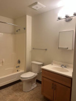 Modern bathroom of 1 bedroom apartment in Arcadia with shower, sink, and toilet features.