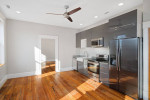 Modern kitchen in a 2 bedroom apartment featuring granite countertops and hardwood floors.