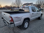 2010 Toyota Tacoma TRD Sport Quad Cab 4x4 in silver with clean exterior and interior, showcasing rear view.