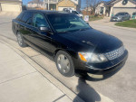 2004 Toyota Avalon XLS FWD parked on the street, showing minor exterior flaws and a clean interior.