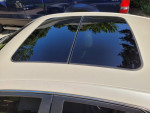 Close-up of the sunroof on a 2013 Cadillac CTS in pearl white, showcasing its sleek design and maintenance.