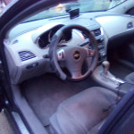 Interior view of a 2011 Chevrolet Malibu with clean dashboard and modern controls.