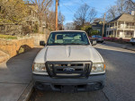 Front view of a 2011 Ford Ranger in good condition parked on the street, with visible minor wear.