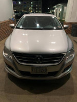 Front view of a 2010 Volkswagen CC with silver exterior, represented in good condition, parked at night.
