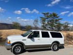 Clean 2001 Ford Excursion SUV with 5.4L V8 parked outdoors, showcasing its rust-free condition and spacious design.