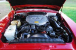 Engine bay of a 1985 Mercedes 380SL in excellent condition with new parts and red exterior.