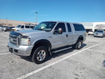 2005 Ford F-250 Diesel Lariat truck with low mileage, parked in a clean lot under a clear sky.