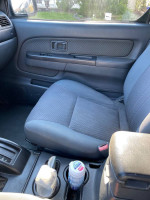 Interior view of a 2003 Nissan Xterra showing the driver's seat and console, ideal for DIY repairs.
