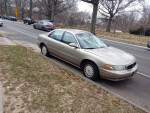 2001 Buick Century parked on the street, offering low mileage and used condition with various repairs needed.