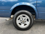 Close-up of the wheel and tire of a 2004 Chevrolet Astro Cargo Van, showcasing its original condition and maintenance.