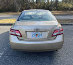 Rear view of a 2011 Toyota Camry in good condition with low mileage and no accidents.