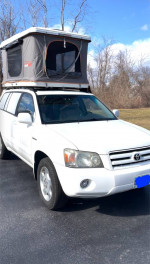 2005 Toyota Highlander Limited SUV with roof tent for camping, white exterior and grey leather interior.
