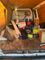 Interior view of a 2005 E250 work van filled with tools and equipment, ready for work in Fort Mill, SC.