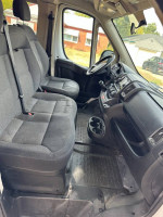 Interior view of a Promaster 1500 diesel van with grey seats and dashboard, showing wear and tear.