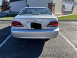 Rear view of a silver 2005 Lexus ES 330 with low mileage, parked in a lot.