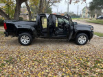 2021 Chevrolet Colorado LT 4WD in excellent condition parked with open doors among fallen leaves