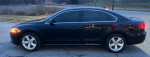 Side view of a 2013 Volkswagen Passat SE FWD, black, with 72,000 miles and clean title.
