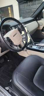 Interior view of a 2018 Land Rover Range Rover HSE showing steering wheel and leather seats