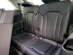 Rear seating area of a 2019 Audi Q7, featuring leather upholstery and ample space for passengers.