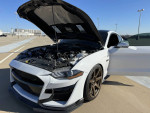 2020 Ford Mustang GT Premium in Oxford White, hood open revealing engine and performance upgrades.
