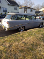 Side view of a classic 1956 Chevrolet Belair Beauville 9 passenger wagon parked on a lawn