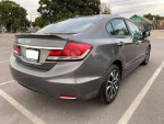 Gray Honda Civic with clean title, 114k miles, and good tires parked in a lot.