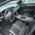 Interior view of a Honda Civic Sport showcasing the dashboard, touchscreen, and seating.