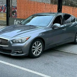 Gray INFINITI Q50 Premium sedan with leather interior and sunroof parked on the street