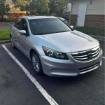 Silver Honda Accord parked, featuring leather seats, Bluetooth, and a clean title.