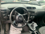 Interior view of a 2015 Kia Soul, featuring dashboard, steering wheel, and gear shift.