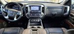 Interior view of a 2018 GMC Sierra 1500 SLT with navigation, premium audio, and leather seats.
