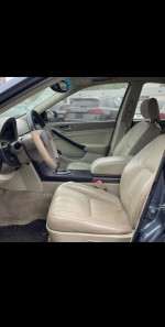 Interior view of a 2003 Infiniti G35 showing clean leather seats and dashboard.
