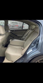 Interior view of a 2003 Infiniti G35 with beige leather seats, clean and well-maintained.