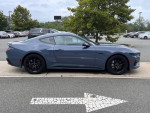 2024 Ford Mustang GT Premium in blue, 3,932 miles, parked in a lot with trees.