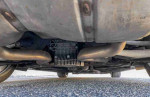 Undercarriage view of a 2008 BMW M3 coupe showcasing exhaust system and engine components.