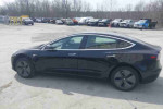 Side view of a black 2020 Tesla Model 3 Standard Range Plus with 49,256 miles, showcasing its sleek sedan design.