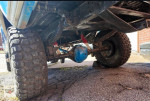Undercarriage view of a 1991 Ford F-250 XL with rugged tires and sound mechanics.