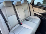 Spacious and clean back seat of a 2018 Honda Civic EX-L with grey interior upholstery.