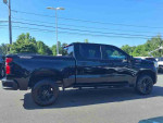 2022 Chevrolet Silverado 1500 Limited Trail Boss in black, showcasing its robust design and features.