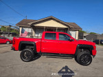 2016 Chevrolet Silverado 1500 Rocky Ridge lifted truck in red with off-road wheels and American flag