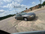 2003 Chevrolet Monte Carlo LS parked in an open area, showcasing its classic coupe design and comfortable style.