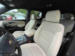 Interior view of a 2022 Chevrolet Traverse High Country with light-colored seats and modern design.